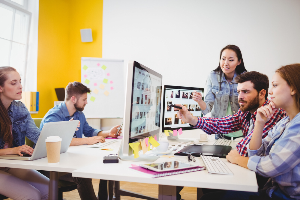 coworkers looking at computer screen