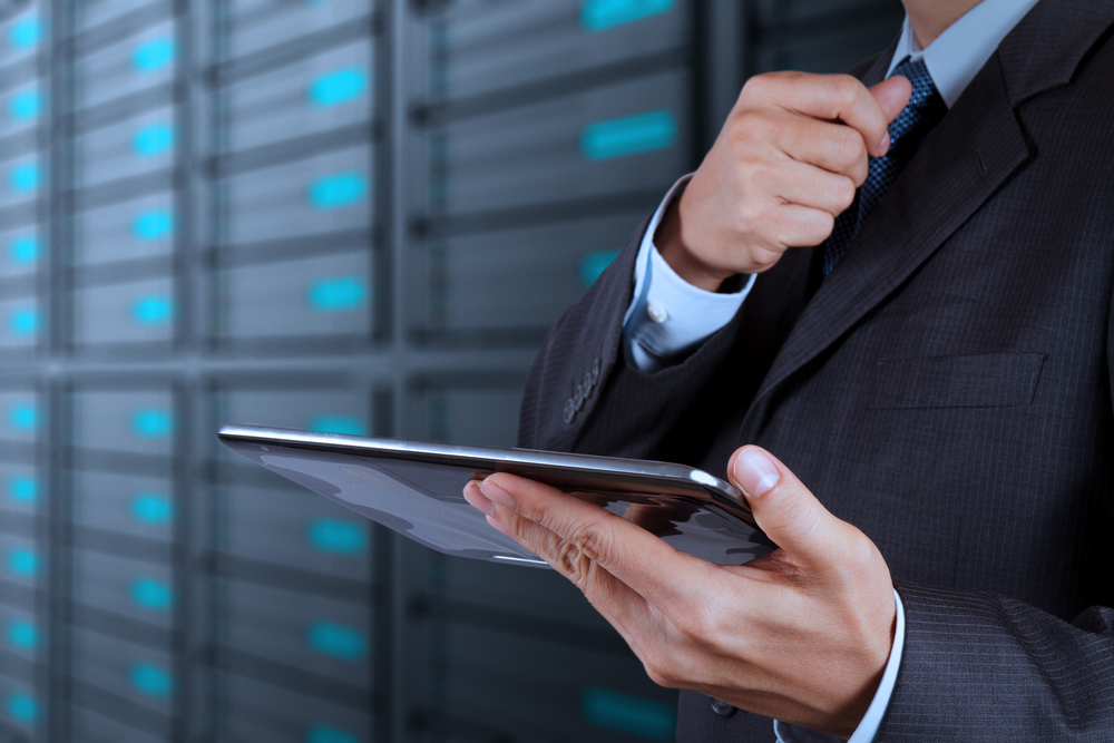 businessman hand using tablet computer and server room background-2